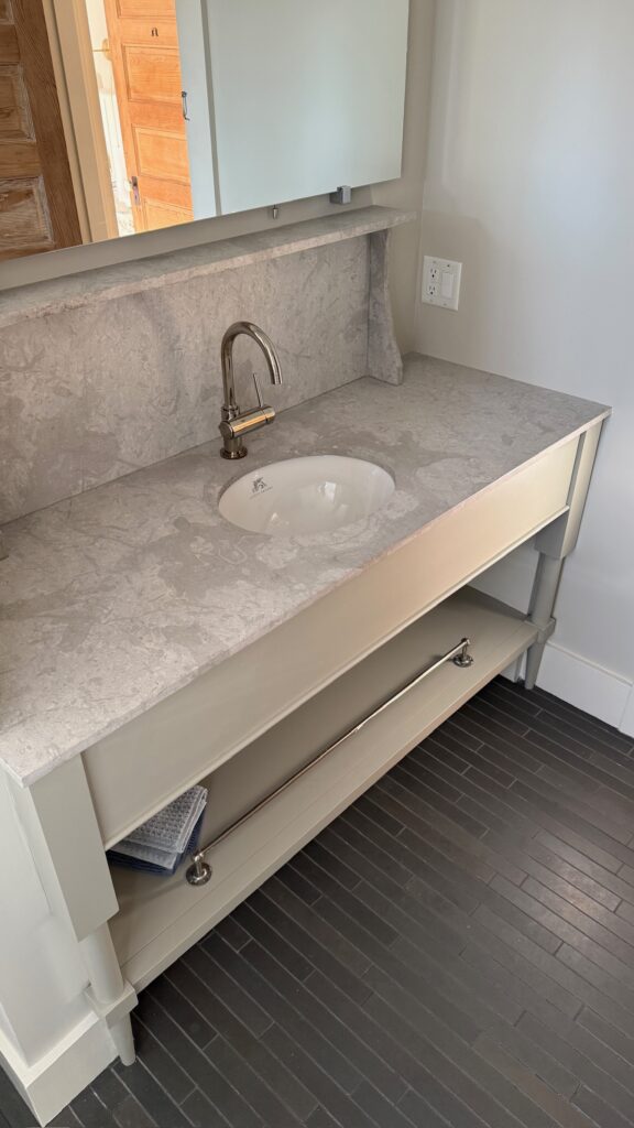 Custom design limestone counter/backsplash with LeFroy Brooks oval sink